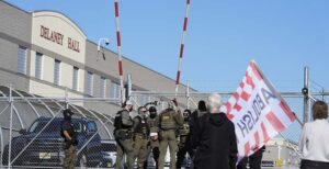 Protesters and security stand in front of Delaney Hall, a recently re-opened immigration detention center, in Newark, N.J., Wednesday, May 7, 2025