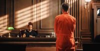 Court of Law and Justice Trial Proceedings: Law Offender in Orange Jumpsuit is Questioned and Giving Testimony to Judge, Jury. Criminal Denying Charges, Pleading, Inmate Denied Parole.