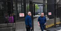 A fence surrounds the Everett McKinley Dirksen federal courthouse in Chicago as people enter and exit the building