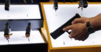 A person tries out a handgun during a gun show