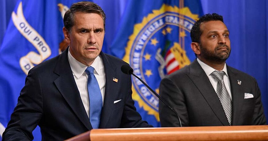 Todd Blanche speaks as FBI Director Kash Patel stands by his side during a press conference