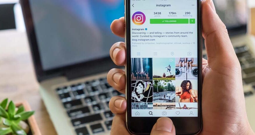 A person holds a smartphone with the Instagram app open
