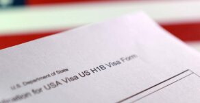 A U.S. flag and a U.S. H-1B Visa application form are seen in this illustration