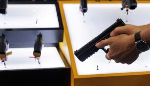A person tries out a handgun during the annual National Rifle Association meeting in Dallas, Texas in 2024.