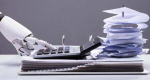 Robotic hand shown using a calculator, with a stack of papers behind it, AI concept